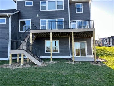 Full composite deck installation with stairs and support posts on Long Lake two-story home