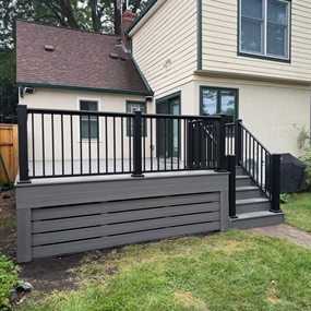 Minneapolis composite deck rebuild with Deckorators Sierra decking, black railing, and enclosed lower perimeter