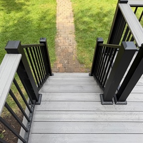 Custom deck stairs aligned with existing stone walkway on Minneapolis low-elevation deck rebuild